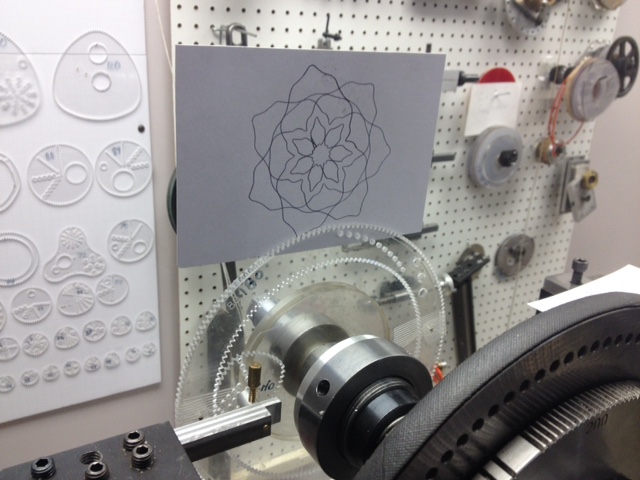 Rose engine with wild gears and design on paper.